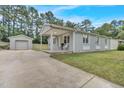 Lovely home featuring a covered porch with seating and a detached garage at 3312 Apache Dr, Raleigh, NC 27609