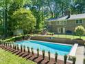 A backyard pool with manicured hedges and a diving board enhance the property's appeal at 3420 Sheridan Dr, Durham, NC 27707