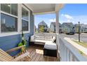Inviting front porch featuring comfortable seating and a view of the peaceful neighborhood street, perfect for relaxation at 353 Rivella Dr, Wake Forest, NC 27587