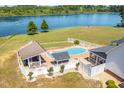 Aerial view of a beautiful pool with custom cabana, bar, and golf putting area at 3636-A Holly Grove Rd, Dunn, NC 28334