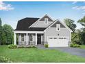 New home with a welcoming front porch, two-car garage, lush green lawn, and neutral toned facade at 440 Golden Dragonfly St, Wake Forest, NC 27587