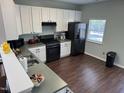 Kitchen featuring stainless steel appliances, modern lighting, and an airy atmosphere at 4910 Briarstone Ct, Raleigh, NC 27610