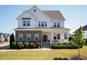 Beautiful two-story home featuring a welcoming front porch, stone accents, and professionally landscaped yard at 536 Adkins Ridge Rd, Rolesville, NC 27571