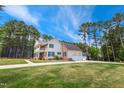 Spacious two-story home featuring a side-entry garage, manicured lawn, and a blend of brick and siding at 55 Fleming Forest Dr, Youngsville, NC 27596