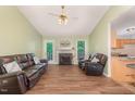 Inviting living room with vaulted ceiling, fireplace, wood flooring and natural light at 5600 Sherrif W Pl, Raleigh, NC 27610