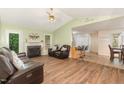 Inviting living room featuring fireplace, wood flooring, open layout and vaulted ceiling at 5600 Sherrif W Pl, Raleigh, NC 27610