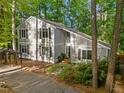 Exterior shot featuring a well-maintained home, mature trees and a covered parking area at 568 Piney Mountain Rd, Chapel Hill, NC 27514