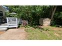 Backyard featuring a deck, a storage shed, and a partially wooded area at 6125 Bellow St, Raleigh, NC 27609