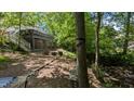 Beautiful backyard with a deck, patio, and wooded area, perfect for relaxation at 6125 Bellow St, Raleigh, NC 27609