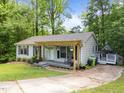 Inviting front porch featuring a pergola and seating area, perfect for relaxing outdoors at 6125 Bellow St, Raleigh, NC 27609