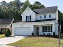 Inviting two-story home with a manicured lawn, garage, and covered front porch at 637 Prickly Pear Dr, Fuquay Varina, NC 27526