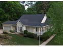 Aerial view of the home showing the roof, well-manicured lawn, mature trees and covered front porch at 7716 Micklewaithe Ct, Wake Forest, NC 27587