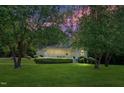 Charming home featuring a well-maintained lawn and inviting front porch at dusk at 7716 Micklewaithe Ct, Wake Forest, NC 27587