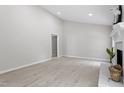 Bright living room featuring a cozy fireplace, arched window, and sliding glass door at 7824 Knightdale Blvd, Knightdale, NC 27545