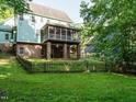 Spacious backyard showcasing a fenced yard, brick patio and second story screened in porch at 816 Roanoke Dr, Cary, NC 27513
