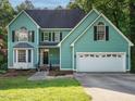 Inviting two-story home with well-manicured lawn and two-car garage at 816 Roanoke Dr, Cary, NC 27513