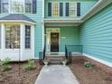 Welcoming home entrance featuring a cozy porch with black iron railings and planters at 816 Roanoke Dr, Cary, NC 27513
