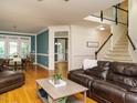 Inviting living room featuring hardwood floors, comfortable seating, and elegant trim details at 816 Roanoke Dr, Cary, NC 27513