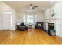 Inviting living room with hardwood floors, fireplace, and bay window offering abundant natural light at 816 Roanoke Dr, Cary, NC 27513