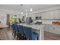 Modern kitchen featuring gray cabinetry, stainless steel appliances, granite countertops and a spacious island with breakfast bar at 820 Laurel Gate Dr, Wake Forest, NC 27587