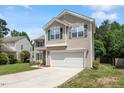 Two-story home with green shutters, two-car garage and well-manicured lawn on a sunny day at 8408 Haines Creek Ln, Raleigh, NC 27616