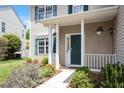 Charming front porch with decorative plants, stylish number art and green front door at 8408 Haines Creek Ln, Raleigh, NC 27616
