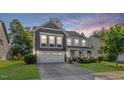 Charming two-story home boasts manicured lawn and a two-car garage at 846 Lake Artesia Ln, Fuquay Varina, NC 27526