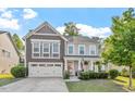 Charming two-story home boasts manicured lawn and a two-car garage at 846 Lake Artesia Ln, Fuquay Varina, NC 27526