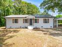 Charming white brick home featuring a metal roof and brown shutters at 8731 Raleigh, Benson, NC 27504