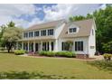 Inviting home showcasing a sprawling front yard, covered porch, and attached garage at 101 Cardinal Dr, Youngsville, NC 27596