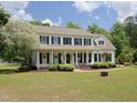 Attractive two-story home with a covered front porch, lush landscaping, and inviting appeal at 101 Cardinal Dr, Youngsville, NC 27596