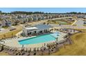 A bird's-eye view captures the community pool, clubhouse, playground, and tennis courts, creating an active lifestyle at 1033 Channel Drop Lp, Zebulon, NC 27597