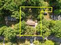 Aerial view of a single-story home, surrounded by mature trees and a well-maintained yard at 108 Jefferson Dr, Durham, NC 27712