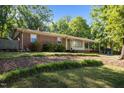 Charming single-story home with a brick facade, mature landscaping, and a manicured lawn at 108 Jefferson Dr, Durham, NC 27712