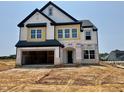 New construction home with a two-car garage and a black and white color scheme at 109 Moonflower Ln # Homesite 260, Wilson's Mills, NC 27520