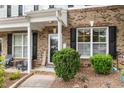 Inviting front porch with brick accents, a 'Welcome' sign, and comfortable seating at 1096 Kelso Ln # 18, Burlington, NC 27215