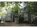 Exterior view of condominium shows green paint, white trim, and multiple windows at 1211 Westview Ln # 201, Raleigh, NC 27605