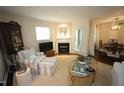Traditional living room with fireplace and adjacent dining room in neutral paint color scheme at 1211 Westview Ln # 201, Raleigh, NC 27605