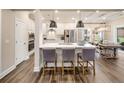 Modern kitchen features stainless steel appliances, quartz countertops and pendant lighting at 1602 Red Roses Way, Durham, NC 27703