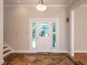 Elegant foyer with decorative tile flooring, a glass-paneled front door, and views of the staircase at 1605 Park Dr, Raleigh, NC 27605