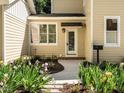 Close up of house entrance with charming landscaping including irises and dark brown mulch around the sidewalk at 1605 Park Dr, Raleigh, NC 27605