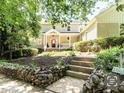 Charming two-story home with a welcoming front porch and stone-lined flower beds leading to the entrance at 1605 Park Dr, Raleigh, NC 27605