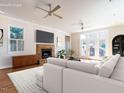 Bright living room with a stone fireplace, ceiling fans, and access to the outdoors at 1605 Park Dr, Raleigh, NC 27605