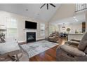 Open-concept living room with hardwood floors, fireplace, and a view of the dining area, great for entertaining at 200 Heather Brook Cir, Spring Lake, NC 28390