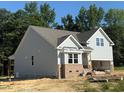 New construction home featuring a gray siding, a bay window, and a 2-car garage at 214 Alden Way, Angier, NC 27501