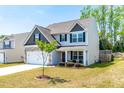 Beautiful two-story home with a well-kept lawn and classic architectural details at 224 Brisk Dr, Zebulon, NC 27597