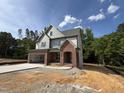 Stylish two-story home showcasing brick and siding exterior, with a two-car garage and a spacious front yard at 2408 Eagle Shot Ct # 4, Fuquay Varina, NC 27526