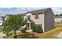 Front side view of a two-story home featuring neutral siding, and manicured landscaping at 2522 Dalmahoy Ln, Fuquay Varina, NC 27526