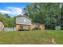 Expansive backyard with a wooden deck, perfect for outdoor entertaining and relaxation at 2608 Foxgate Dr, Raleigh, NC 27610