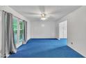 Bright living room featuring a large window, ceiling fan, and neutral paint at 2608 Foxgate Dr, Raleigh, NC 27610